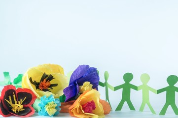  Paper flowers and people in LGBT rainbow colors