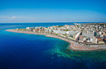 Obraz na płótnie Canvas Aerial birds eye view drone photo of Elli beach on Rhodes city island, Dodecanese, Greece. Panorama with nice sand, lagoon and clear blue water. Famous tourist destination in South Europe