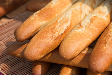 Baguettes, the famous long and thin french bread. Close up of some baguettes in a row.