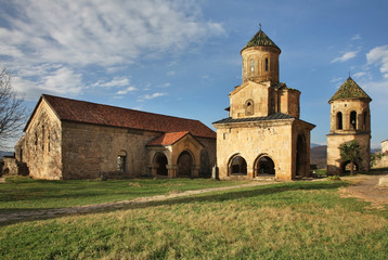 Fototapeta na wymiar Church of St. Nicholas and bell tower at Gelati Monastery of Theotokos near Kutaisi. Imereti Province. Georgia