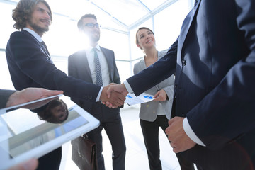 employees look at the handshake business partners