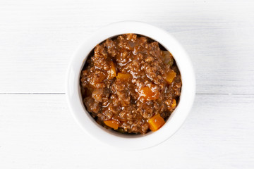 Bolognese sauce. In a white plate. The background is white. Italian food. Copy space. Top view. Horizontal shot.