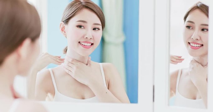 woman apply cream with neck