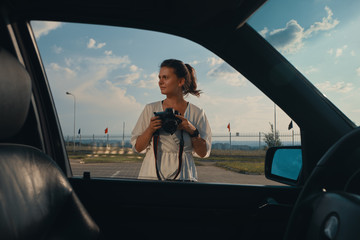 Travel woman taking photo between road trip