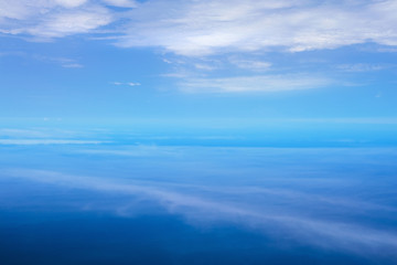 Naklejka na ściany i meble Aerial view with cloud ripples above the ocean and fluffy cloudscape