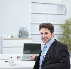 Fototapeta premium closeup.handsome businessman sitting in this Desk