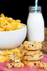 Breakfast concept,Cookies and Cornflake cereals with milk glass on table.