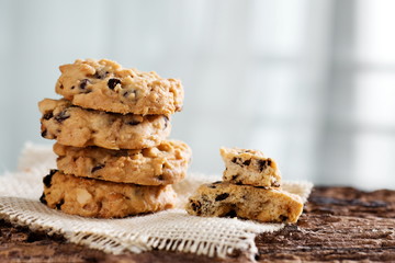 Pile of chocolate chip cookies on sackcloth.