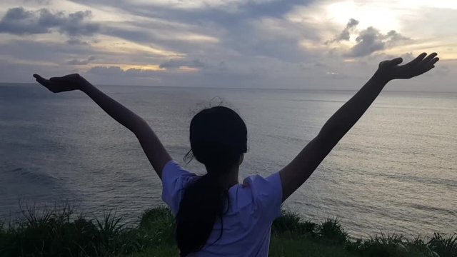 A female teenager viewing the endless ocean from the top of the hill. Shot in Basco, Batanes.