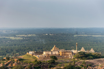 Shravanabelagola, Karnataka, India - November 1, 2013: Seen from Bhagwan Bahubali Jain Tirth. Chandragupta Basadi, Digambar Jain Mandir and Bhagwan Bharat temple complex on hill. Plains in back.