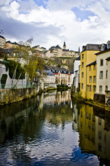 Fototapeta na wymiar View down the Alzette River with the Beautiful Traditional Buildings of the Village of Grund in Luxembourg City, Luxembourg