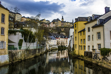 Fototapeta na wymiar Traditional European Buildings in the Village of Grund Reflecting on the Water of the Alzette River in Luxembourg City, Luxembourg