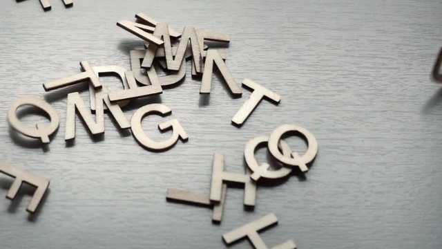Wooden alphabet letters falling in slow motion