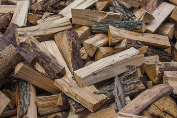 Woodpile of chopped lumber. Pile of wood logs. Stacked firewood timber