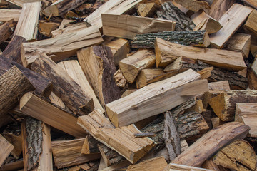 Woodpile of chopped lumber. Pile of wood logs. Stacked firewood timber