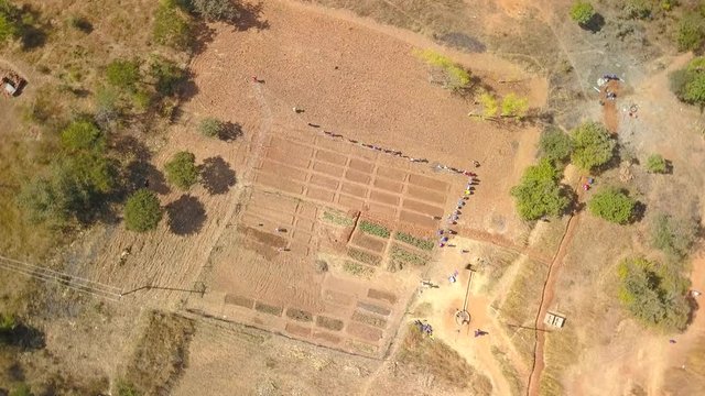 Flying Down To A Garden In Rural Africa, Overhead Descending Drone Shot