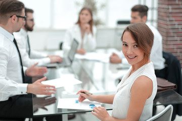 smiling young business woman at workplace in office