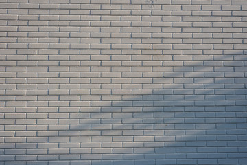White brick wall with textures at sunset.