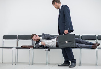 businessman talking to a tired visitor