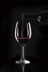 wine bottle with glass on the black