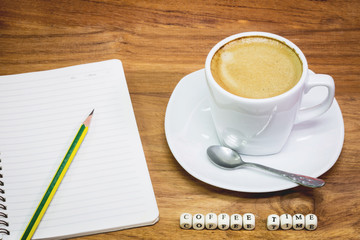 Cup of coffee with note book and pencil