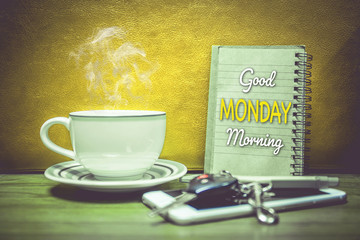 A cup of coffee cell phone and key of car.