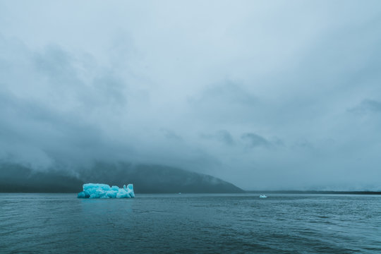Iceberg in foggy and stormy water