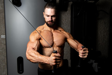 Fototapeta na wymiar Muscular Man Exercising Chest