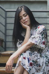 Fototapeta premium Fashionably dressed asian woman on the natural outdoors