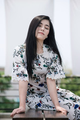 Fototapeta premium Fashionably dressed asian woman on the natural outdoors