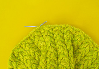 Yellow and green coats of wool lie on the table.