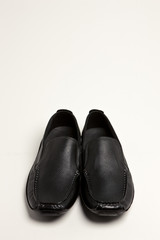 black leather shoes on the white background.