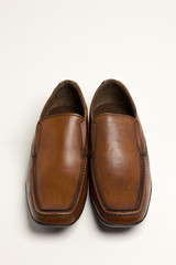 brown leather shoes on the white background.