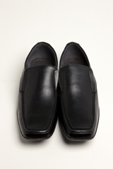 black leather shoes on the white background.
