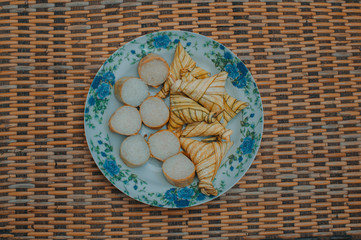 Lemang and ketupat (bamboo rice and rice dumpling) with rendang on bamboo mat.