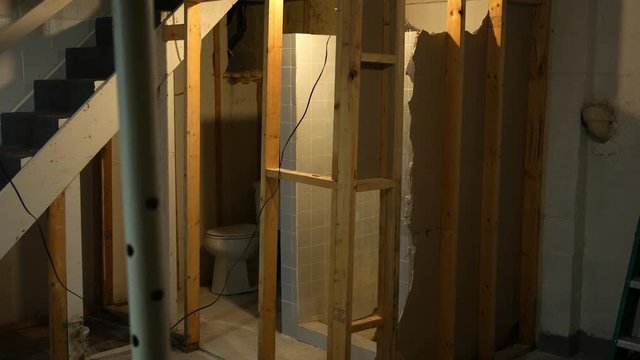 A demolished basement bathroom in the early state of remodel