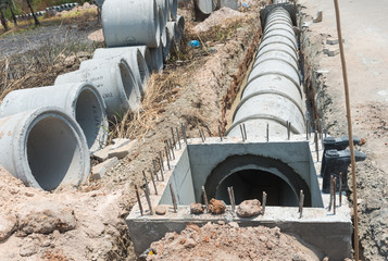 Row of Concrete Drainage Pipe on a Construction Site .Concrete pipe stacked sewage water system aligned on site.