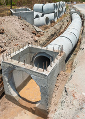 Row of Concrete Drainage Pipe on a Construction Site .Concrete pipe stacked sewage water system...