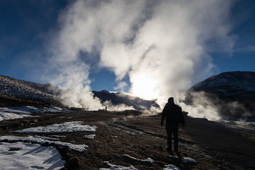 Traveler man at Geyser field El Tatio, near San Pedro de Atacama, Chile.