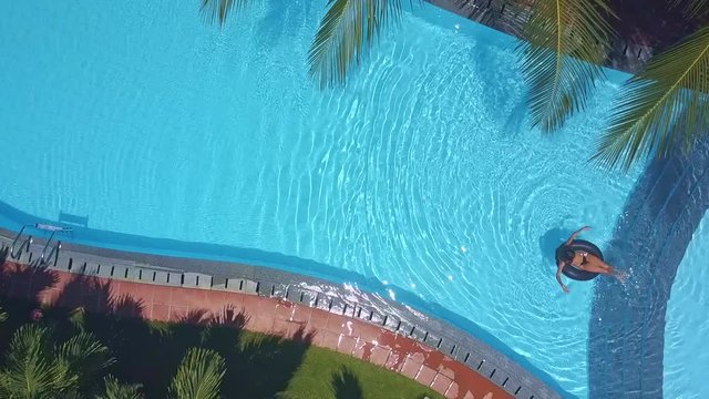 sun glare on pool water near swimming girl