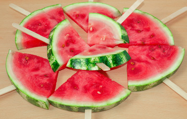 Still life, slices of watermelon, on a wooden stick.