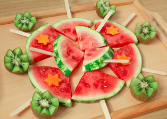 Still life, slices of watermelon, on a wooden stick. And carved kiwi.