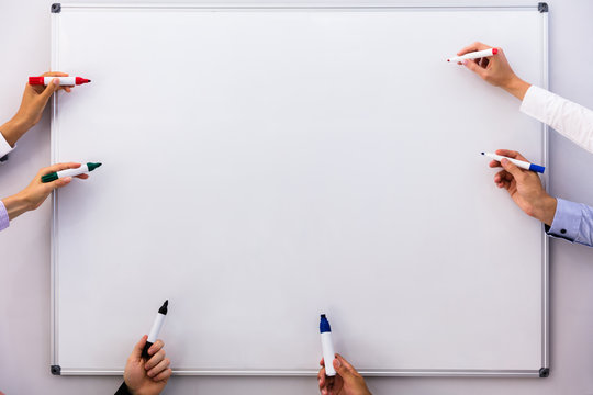 Businesspeople Writing On Blank White Board