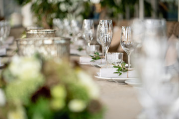 Wedding Banquet or gala dinner. The chairs and table for guests, served with cutlery and crockery. Covered with a linen tablecloth runner. party on terrace