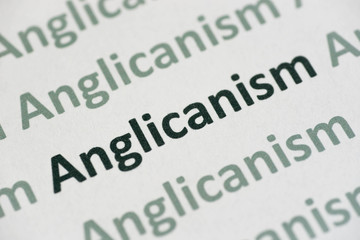 Fototapeta premium word Anglicanism printed on paper macro