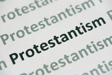 Fototapeta premium word Protestantism printed on paper macro