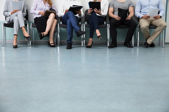 Row Of Candidates Sitting On Chair