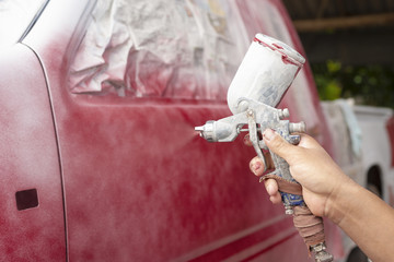 Hands of mechanic working car painting