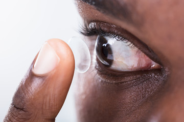 Person Putting Contact Lens In Eye