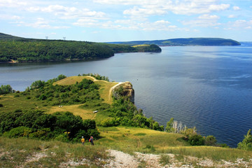 Areal view from Molodezky kurgan to Zhiguli hills and river Volga with blue sky and green grass